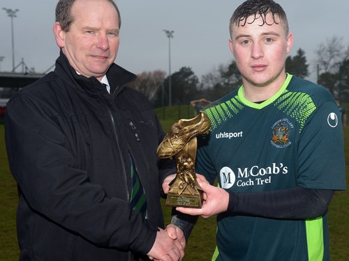 Lisburn Distillery's Jonathan McCaw receives the 'Man of the Match' trophy from Colin McCullough (vice Chairman) of the Irish FA Intermediate Cup Committee.jpg