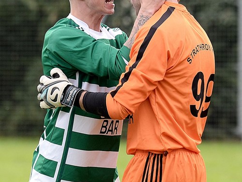 Strathroy keeper Thomasz Antczac celebrates with team mate Mark Gilloway after he saves the decisive penalty.jpg