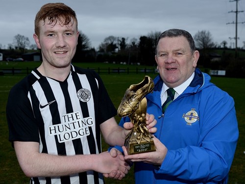 Ciaran Reid receives his man of the match trophy from Enda Love of the IFA Junior Committee.jpg