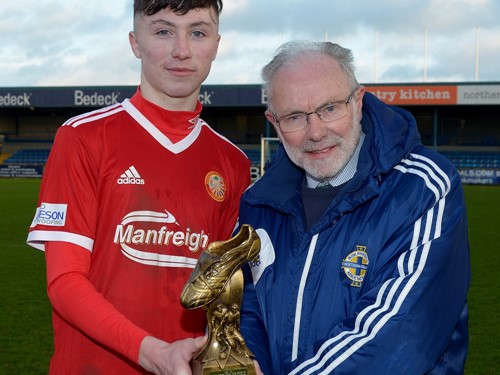 Man of the Match Oisin Conaty recieves his trophy from Brian Larkin of the IFA Youth Committee.jpg