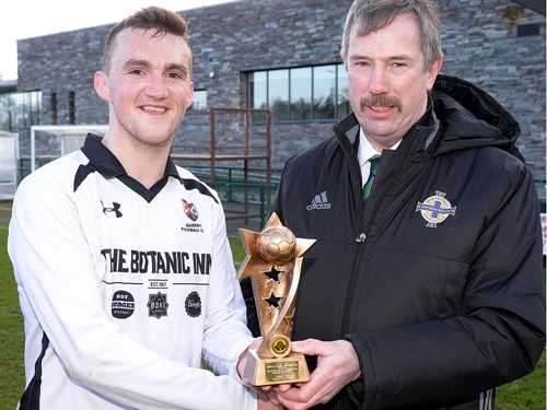 Alistair Gray of the Irish FA Intermediate Committee Presents the %22Man of the Match%22 trophy to Chris Middleton of Queens .jpg