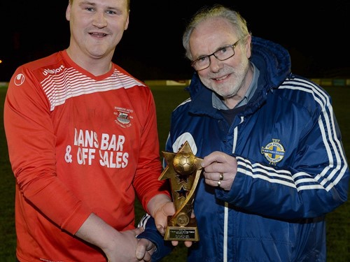 Man of Match Declan Monaghan of Bessbrook United recieves his trophy from Brian Larkin of the Irish FA Junior Committee.jpg