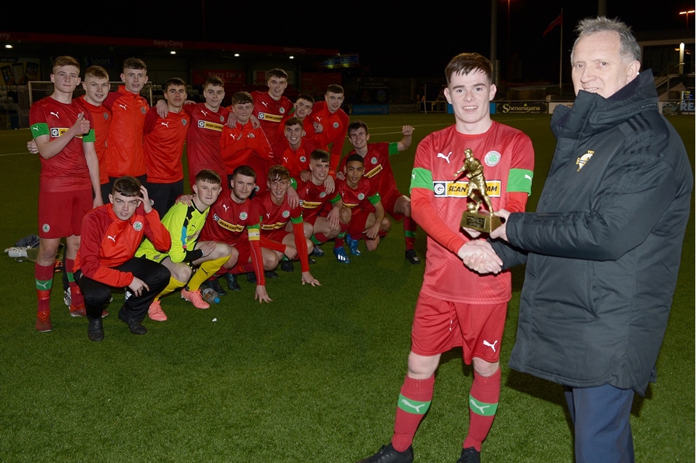Robert Doherty of the Irish FA Youth Committee presents Cliftonville Strollers Peter McKiernan with his “Man of the Match” trophy as his team mates look on.jpg
