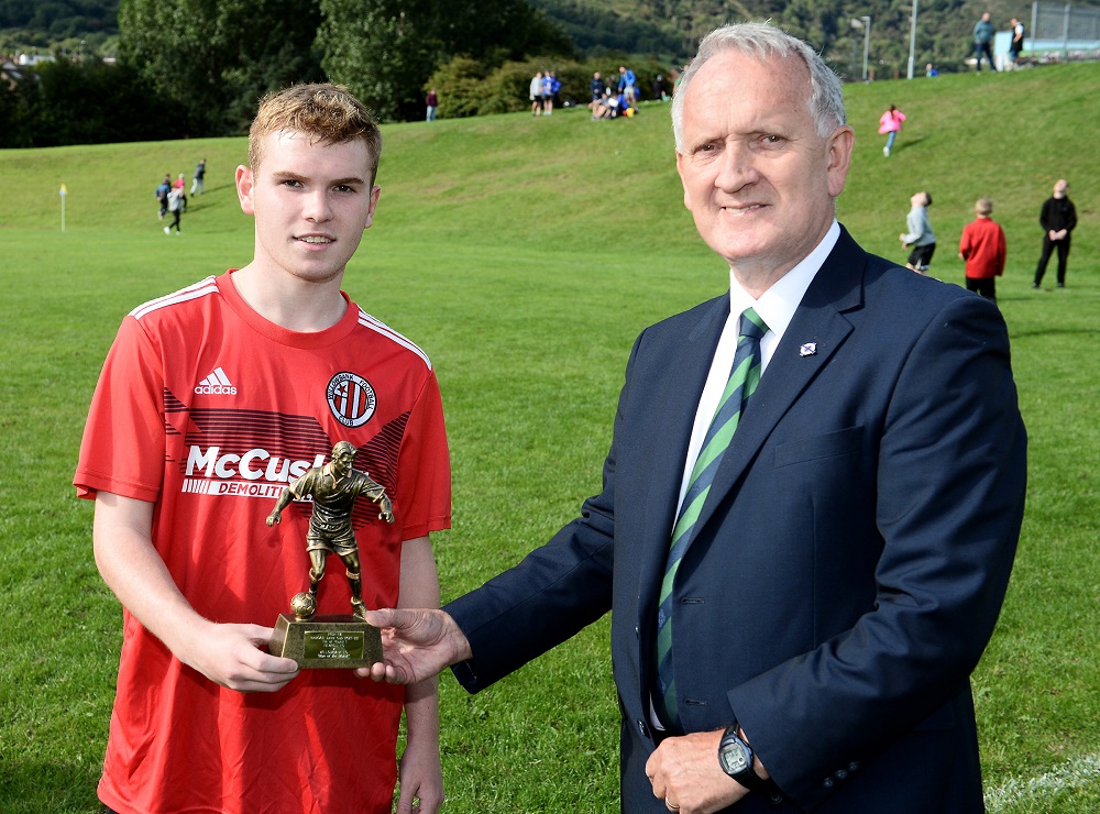 Man of the Match Lee McAllister receives his trophy from Robert Doherty of the Irish FA Junior Committee.jpg