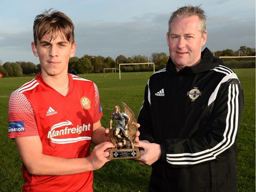 Igor Rutkowski is presented with his Man of the Match trophy by Maurice Johnston of the Irish FA Junior and Youth Committee.jpg
