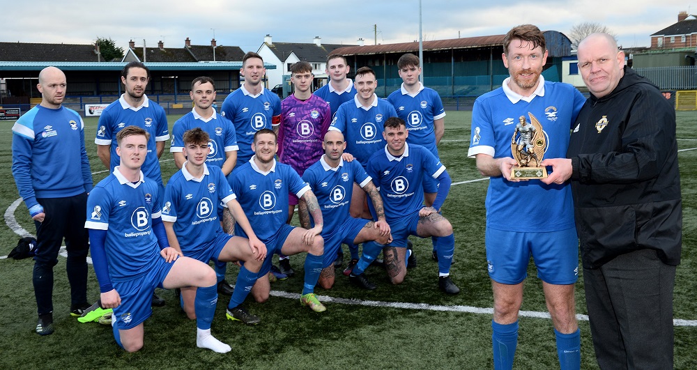 Paul Dickson recieves his Man of the Match trophy from Michael Long of the Irish FA Intermediate Committee as his Bangor team mates look on.jpg