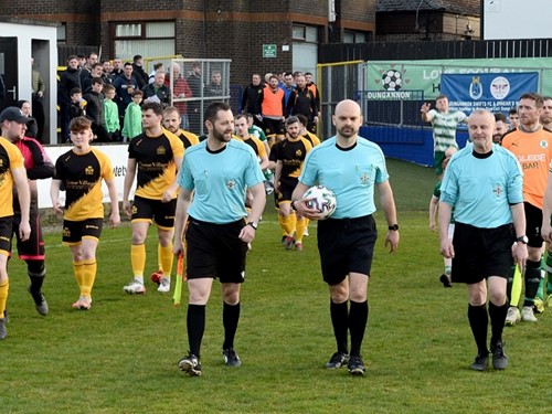 Officials and Teams take to the pitch.jpg