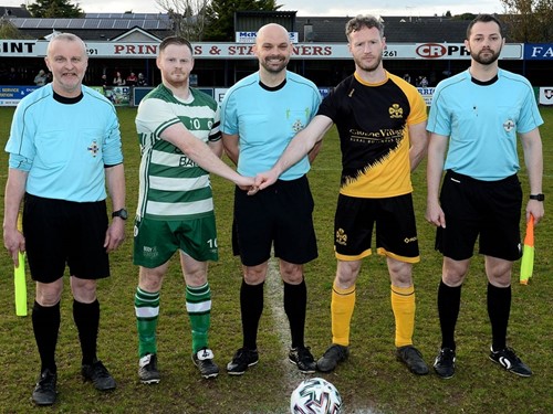 Strathroy Harps captain Caolan McCrossan and Coalisland Athletic captain Gary Coney with the match officials..jpg