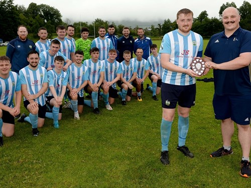 Ards Rangers II's Captain with Shield as team look on .jpg