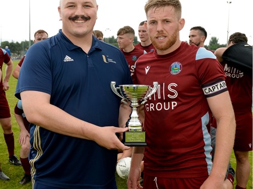 Greenisland 1st's Captain is presented with the Cup.jpg