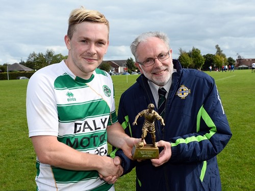 Armagh Celtic's Josh McCarten receives his Man of the Match award from Brian Larkin of the Irish FA Junior Committee.jpg