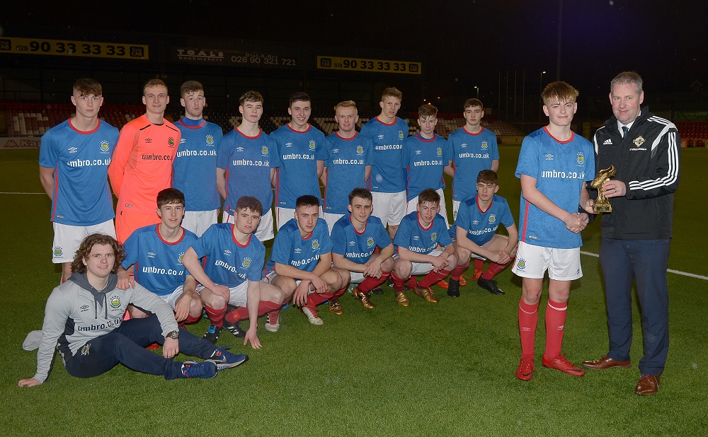 Maurice Johnston, Chairman of the Irish FA Youth Committee, presents Ben Wylie of Linfield Rangers with his 'Man of the Match' trophy.jpg