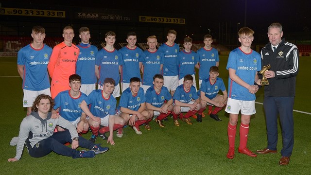 Maurice Johnston, Chairman of the Irish FA Youth Committee, presents Ben Wylie of Linfield Rangers with his 