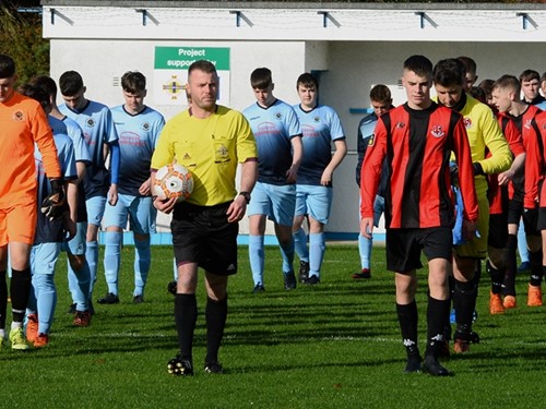 Referee leads out both teams.jpg