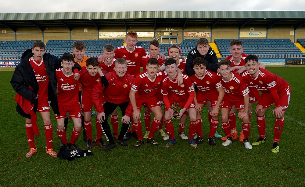 Man of the Match Oisin Conaty of Portadown III's celebrates with his teammates and trophy.jpg