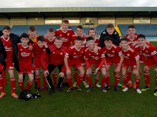 Man of the Match Oisin Conaty of Portadown III's celebrates with his teammates and trophy.jpg