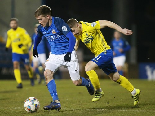 Josh Daniels pushes forward as Alan Teggart gives chase.jpg