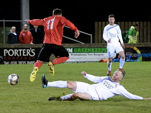 Bessbrook's Conor Giles rides a tackle.jpg