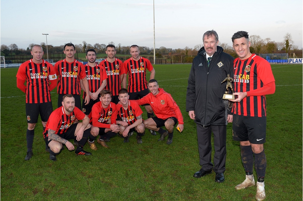 Alistair Gray, Irish FA Intermediate Committee, presents Daniel Purkis with his man of the match award.jpg