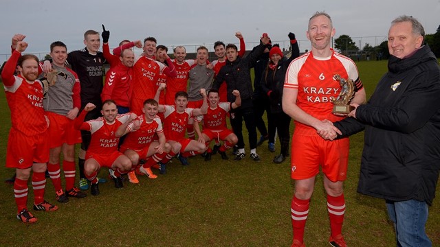 Robert Doherty of the Irish FA Junior committee presents Enniskillen Rangers _Man of the Match_ Neil Coulter with his trophy as his teamates look on.jpg 