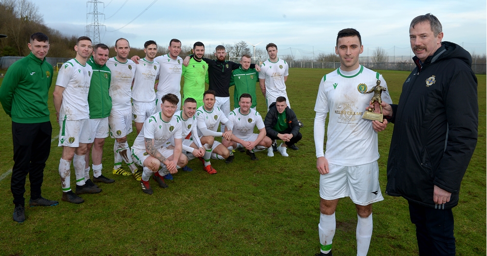Alister Gray of the Irish FA Intemediate Cup Committee presents Belfast Celtic's Darren Stuart with his %22Man of the Match%22 trophy as his team mates look on.jpg