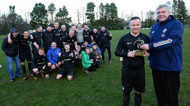 __Man of the Match__Bryan Tosh of Dervock receives his trophy from Wayne Glynn, Vice-Chairman of the Irish FA Junior Committee, as his team mates look on.jpg 