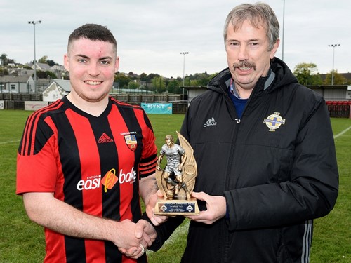 Man of the Match Christopher McMahon of Banbridge Town is presented with his trophy by Alistair Gray of the Irish FA Intermediate Committee.jpg