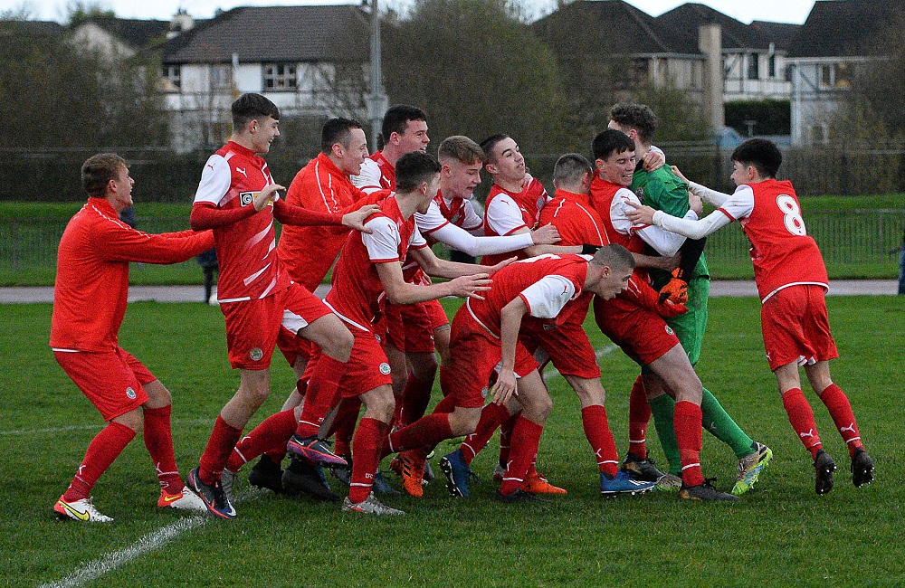 Cliftonville Strollers keeper Orann Donnelly is swamped by his team mates after securing a place in the semi final for the Reds.jpg Cliftonville Strollers keeper Orann Donnelly is swamped by his team mates after securing a place in the semi final for the Reds.jpg