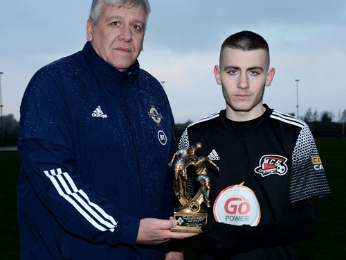 Irish FA Youth Committee vice chairman Wayne Glenn presents Maiden City's Bobby Sweeney with the man of the match trophy .jpg