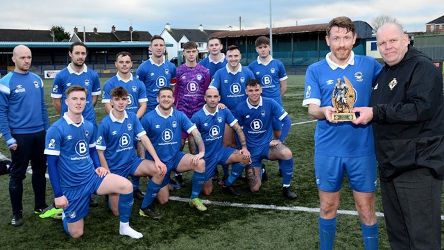 Paul Dickson recieves his Man of the Match trophy from Michael Long of the Irish FA Intermediate Committee as his Bangor team mates look on.jpg 