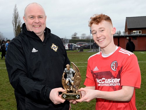Willowbank's Declan Gill is presented with his man of the match award by Ciaran McCrea of the Irish FA Junior Committee.jpg