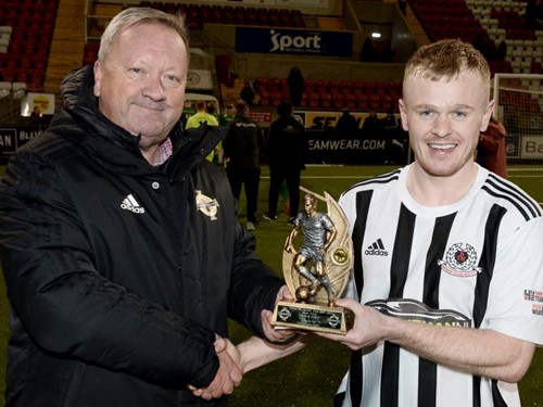 Irish FA Junior Committee chairman Jim Jess presents David Cassells with the man of the match trophy.jpg
