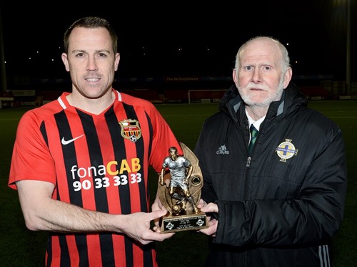 Irish FA Intermediate Cup committee chairman Jerry Stewart presents Jonathan Roy with the man of the match trophy.jpg