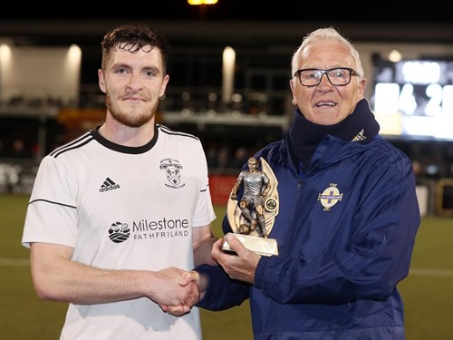 Irish FA Intermediate Cup committee members Brian White presents Rathfriland's Brian Newell with his man of the match trophy.jpg