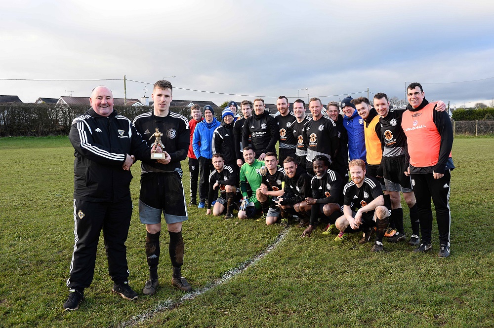 Man of Match Randal Reid with Davy King of IFA Junior Committee as Ahogill team look on (002).jpg Man of Match Randal Reid with Davy King of IFA Junior Committee as Ahogill team look on (002).jpg