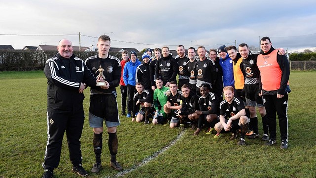 Man of Match Randal Reid with Davy King of IFA Junior Committee as Ahogill team look on (002).jpg 